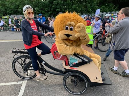 Bridget Hamilton of Cycling Without Age with the Lions mascot